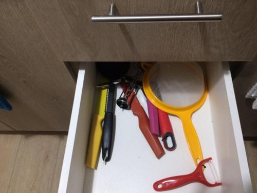 a drawer with different colored office tools in it at Apart Hotel R&P Depto B in Puerto Varas