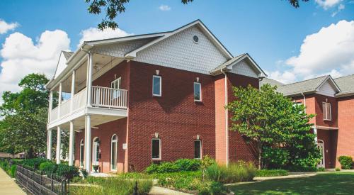 a large red brick building with a balcony at The Respite - Bed and Breakfast in Paducah