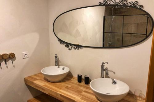 a bathroom with two sinks and a large mirror at ParaLodge in Saint-Vincent-les-Forts