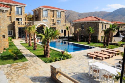 a resort with a swimming pool and some buildings at Anemos Hotel in Gokceada Town