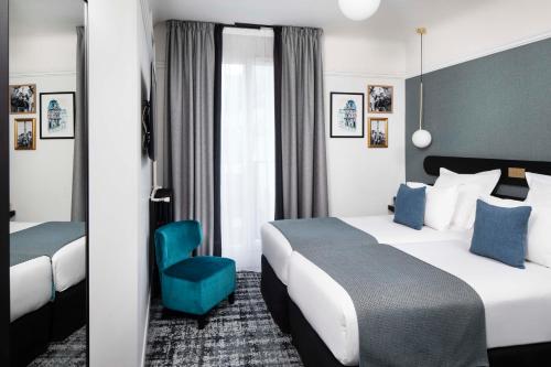 a hotel room with two beds and a blue chair at Maison 46 in Paris