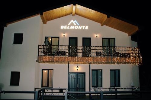 a building with a balcony and a sign that reads blumenthal at Belmonte Kazbegi in Stepantsminda