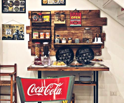 a cocacola store with a counter with food at Il BorGhetto Guest House in Civitavecchia