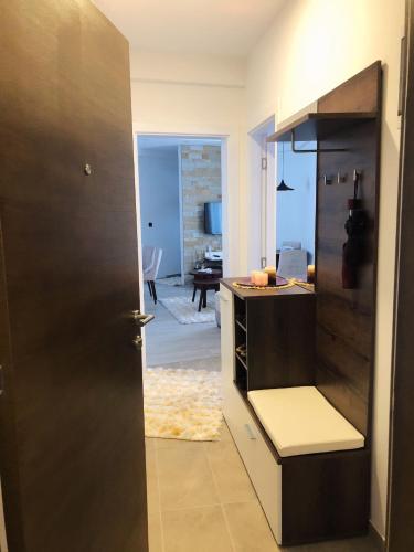 a door leading into a kitchen with a living room at Apartman “EMI” in Kopaonik