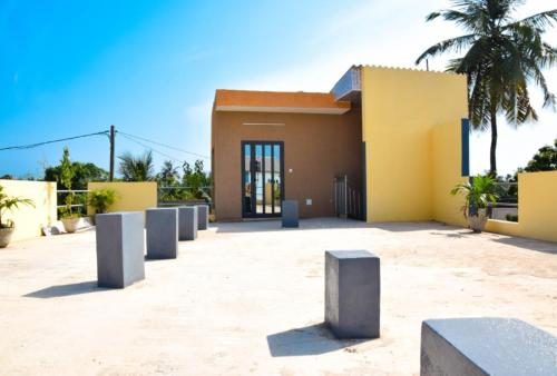 a building with concrete barriers in front of it at Villa Beach Avepozo Lome in Lomé