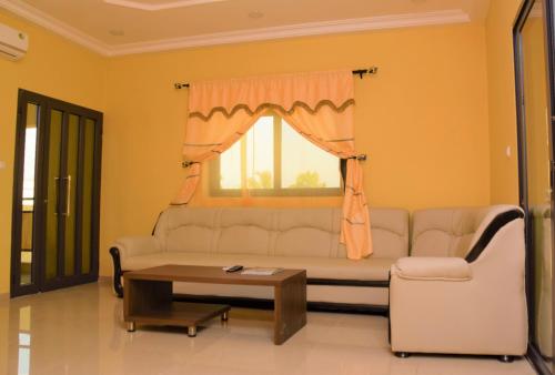 a living room with a couch and a window at Villa Beach Avepozo Lome in Lomé