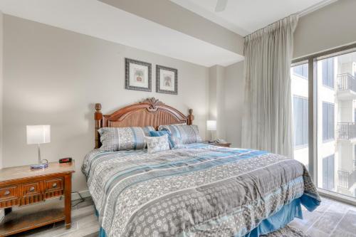 a bedroom with a bed and a large window at Origin at Seahaven in Panama City Beach