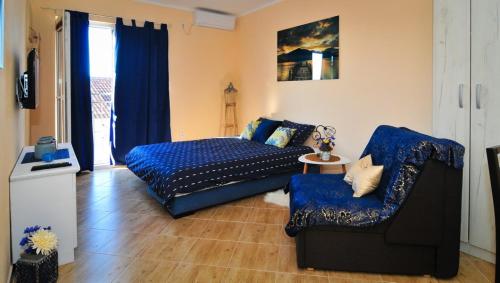 a living room with a couch and a chair at Apartments M&T in Tivat