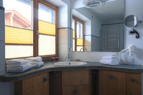 a bathroom with a sink and a mirror at Haus Luna - Apartments in Schwangau