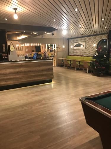 a restaurant with a pool table and a bar at Euro Hôtel Airport Orly Rungis in Fresnes