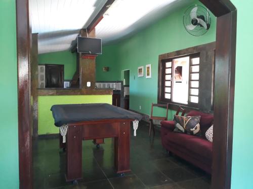 a living room with a table and a couch at Pousada Paraiso do Sol in Saquarema