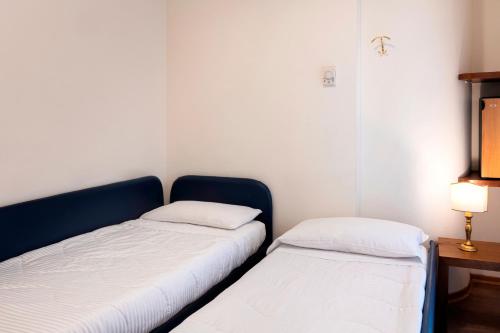 two beds sitting next to each other in a room at International Hotel & Suite in San Benedetto del Tronto