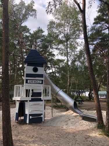 a slide in a park with a playground at Wohnung Bernstein - Nr. 4 in Dierhagen