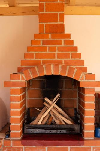 a brick oven with a pile of wood in it at Angela in Polovragi