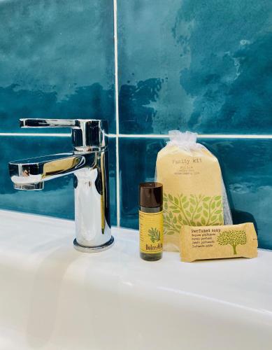 a bathroom sink with a soap dispenser and a bottle of soap at Al castello in Riomaggiore