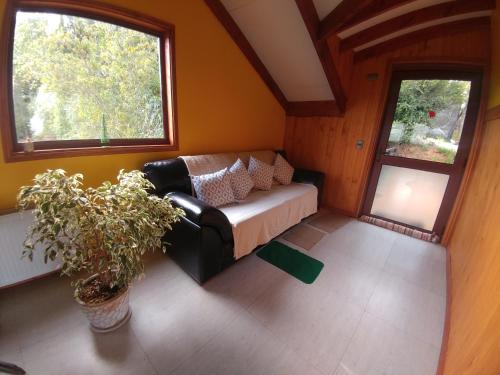 a living room with a couch and a window at La Rueda del Chucao in Valdivia