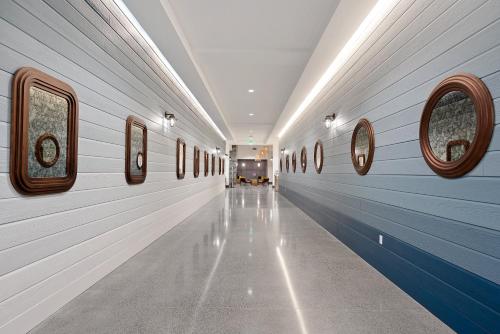 a hallway with blue and white walls and windows at Hotel Indigo Seattle Everett Waterfront Place by IHG in Everett