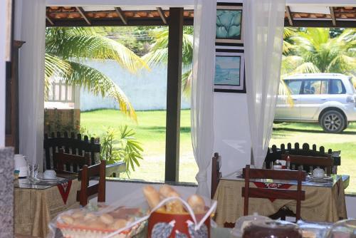 a room with a table with a view of a car at Pousada Piratininga in Niterói
