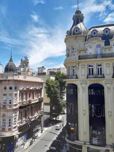 a tall white building on a city street at Hotel Chemin in Buenos Aires