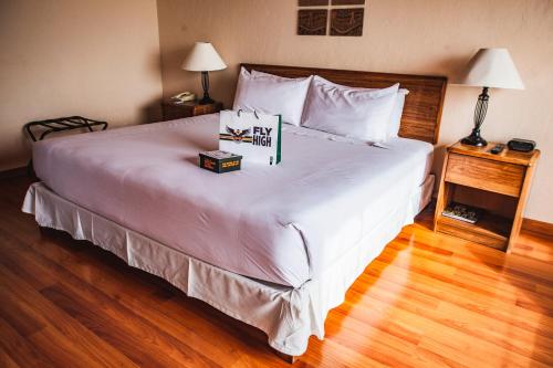 a bedroom with a large bed with a sign on it at BTH Hotel Arequipa Lake in Arequipa