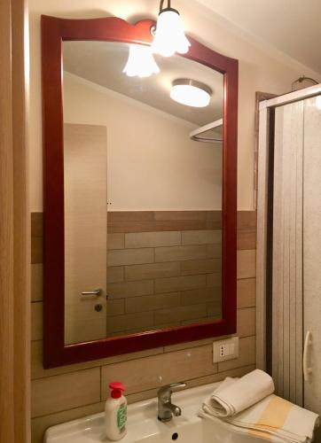 a bathroom with a sink and a large mirror at L'arciere in Celano