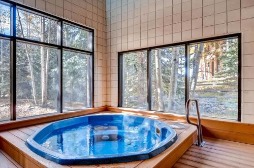a large blue tub in a room with windows at Ski Run Condominiums #108 in Keystone
