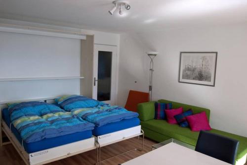 a bedroom with a bed and a couch at Mireille, Appartment 61 in Leukerbad
