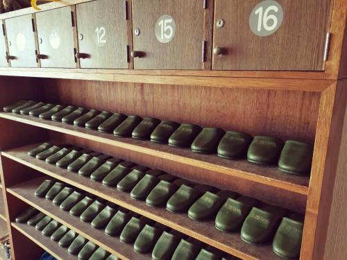 a row of wine bottles in a wine cellar at たから温泉民宿 Gem Onsen Stay in Sakaimura