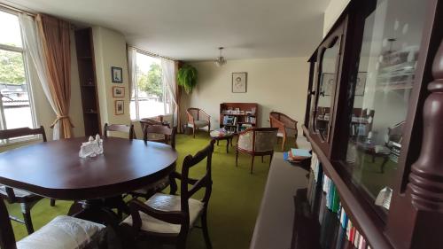 波哥大的住宿－Alojate y Descansa，客厅配有木桌和椅子