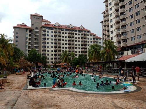 a group of people sitting in a swimming pool at GloRy BeAch ResOrt private apartment in Port Dickson