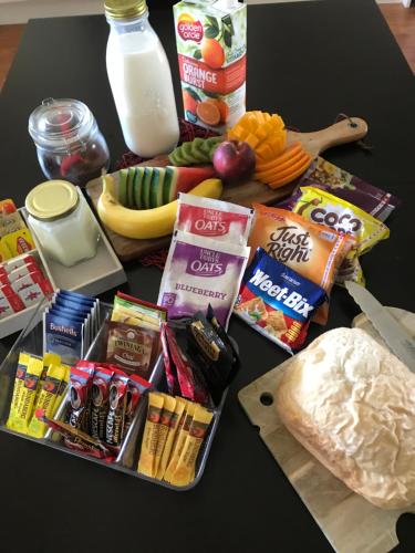 a table with a bunch of snacks and other foods at Tinaroo Sunset Retreat in Barrine