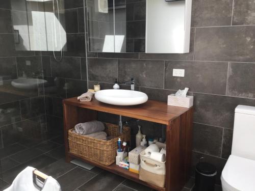 a bathroom with a sink and a toilet at Olivi in Yanakie