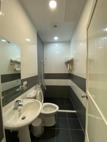 a bathroom with a sink and a toilet and a shower at Lorna Resort in Xinyi