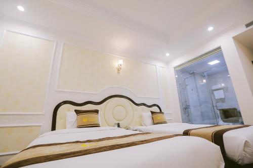 a bedroom with two beds and a window at Vincent Halong Hotel in Ha Long