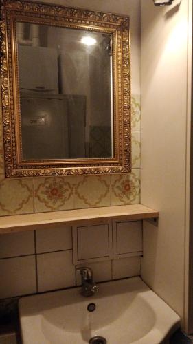 a bathroom with a sink and a mirror on the wall at Prague "Above Train Central" Hostel in Prague