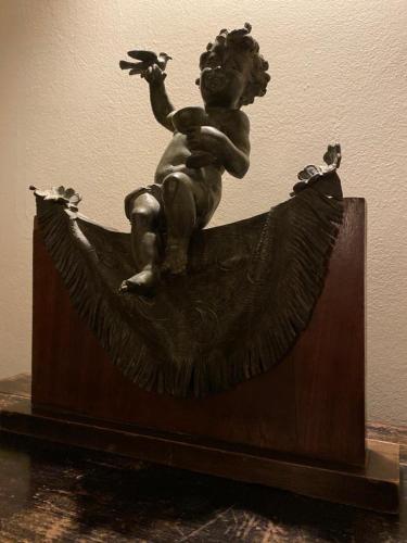 a statue of a cherub sitting in a boat at Sliema La Loggia Suites in Sliema