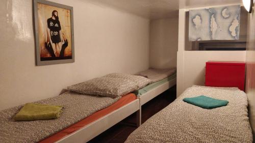 a small room with two bunk beds in it at Prague "Above Train Central" Hostel in Prague
