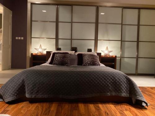 a bedroom with a large bed with two lamps at Sliema La Loggia Suites in Sliema