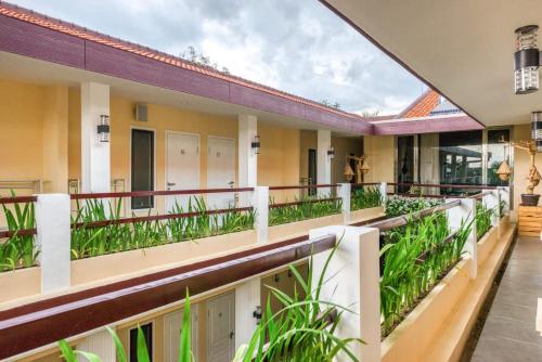 a balcony of a building with plants at RedDoorz Syariah near Kebon Rojo Park Blitar in Karangtengah