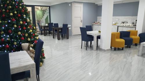 a christmas tree in a restaurant with tables and chairs at Mestia 4 season in Mestia