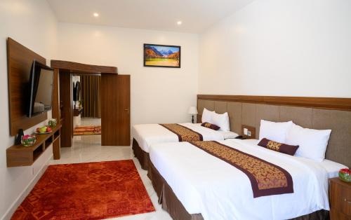 Ένα ή περισσότερα κρεβάτια σε δωμάτιο στο Nhat Quang Hotel