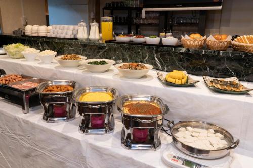 a buffet with different types of food on a table at HOTEL CITY INN WAKAYAMA Wakayama-Ekimae in Wakayama