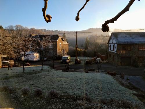 a view of a house and a yard with a building at B&B La Belle Histoire Laforêt in Laforêt