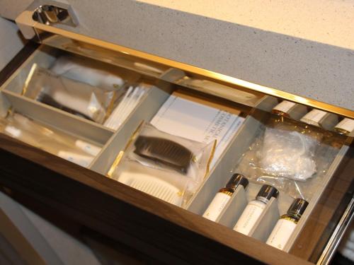 a drawer with several white bottles in it at THE BLOSSOM HIBIYA in Tokyo