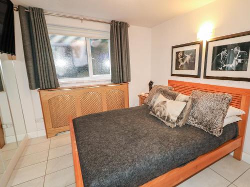 a bedroom with a bed and a window at Beachside and Golf Apartment in Coleraine