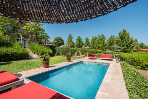 a swimming pool in the backyard of a house at Village Castigno - Wine Hotel & Resort in Assignan