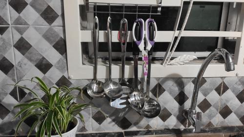 a bunch of utensils hanging on a wall at FRA Homestay in Kuantan