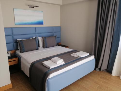 a bedroom with a bed with two towels on it at Doğruer Hotel & Spa in Muğla