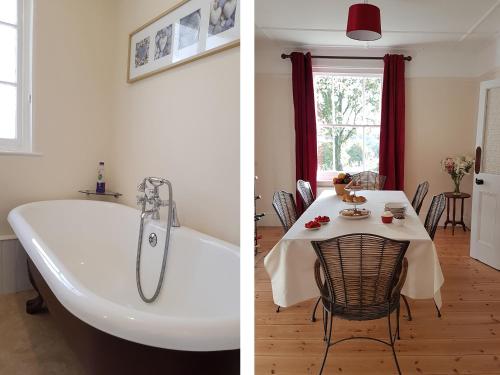 a bathroom with a bath tub and a dining room with a table at Hedgelea in Winkleigh