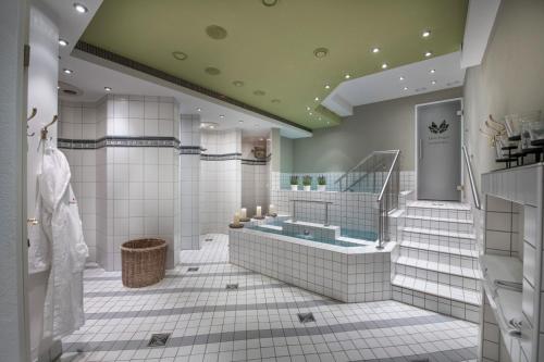 a large bathroom with a tub and a sink at Dein Engel in Oberstaufen